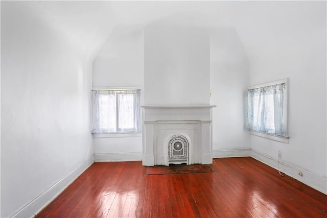 unfurnished living room featuring vaulted ceiling and hardwood / wood-style floors