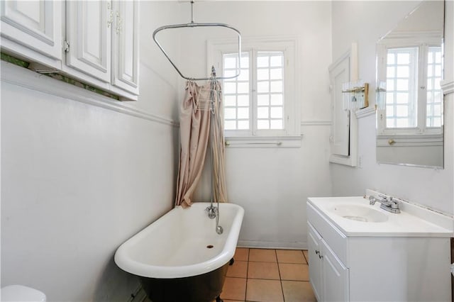 bathroom with tile patterned floors, vanity, and a tub