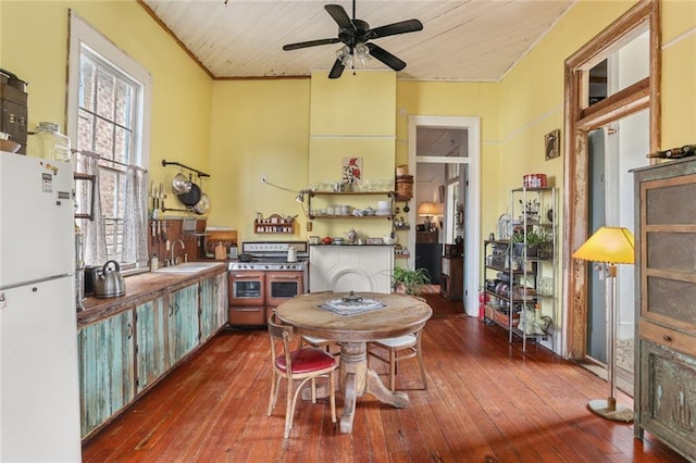 dining space featuring ceiling fan, dark hardwood / wood-style floors, sink, and wooden ceiling