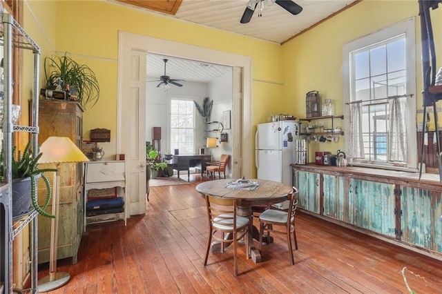 dining space featuring wood-type flooring and ceiling fan