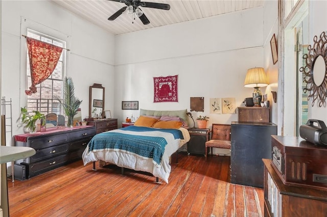 bedroom with ceiling fan and wood-type flooring