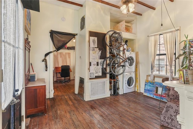 laundry area featuring stacked washer and clothes dryer, dark hardwood / wood-style floors, and ceiling fan