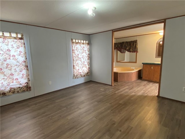 68443 S River Rd, Kentwood, LA 70444 - unfurnished bedroom featuring dark wood-type flooring and crown molding
