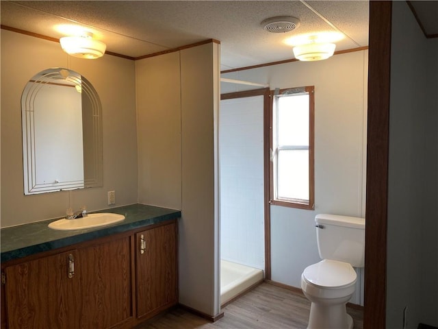 68443 S River Rd, Kentwood, LA 70444 - bathroom featuring hardwood / wood-style flooring, vanity, a textured ceiling, toilet, and walk in shower