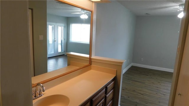 bathroom with vanity, hardwood / wood-style flooring, and ceiling fan