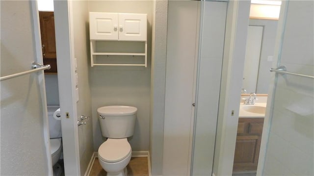 bathroom featuring vanity and toilet