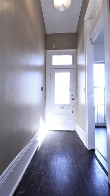 53032 Esplanade Ave, New Orleans, LA 70116 - doorway featuring wood-type flooring, healthy amount of natural light, and baseboards