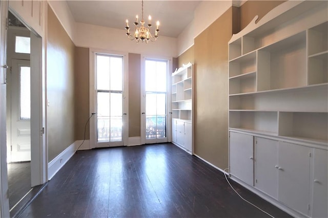 53032 Esplanade Ave, New Orleans, LA 70116 - unfurnished dining area featuring a chandelier, dark wood-style floors, and baseboards