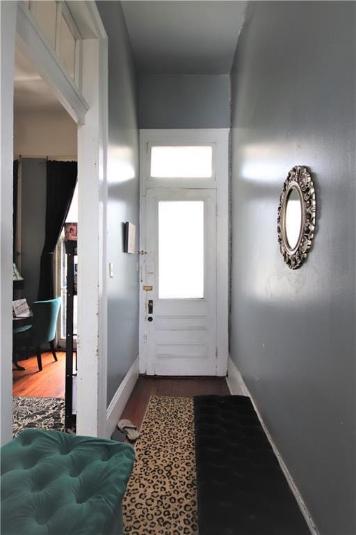 53032 Esplanade Ave, New Orleans, LA 70116 - doorway with baseboards and wood finished floors