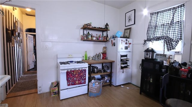 53032 Esplanade Ave, New Orleans, LA 70116 - kitchen with white appliances, wood finished floors, and open shelves