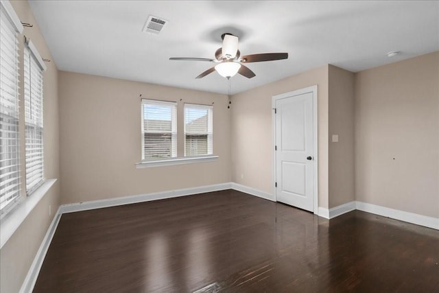 spare room with dark hardwood / wood-style floors and ceiling fan