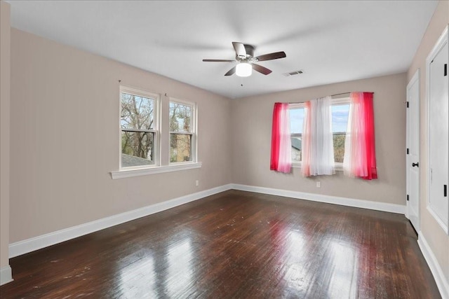 unfurnished room featuring dark wood-type flooring and ceiling fan