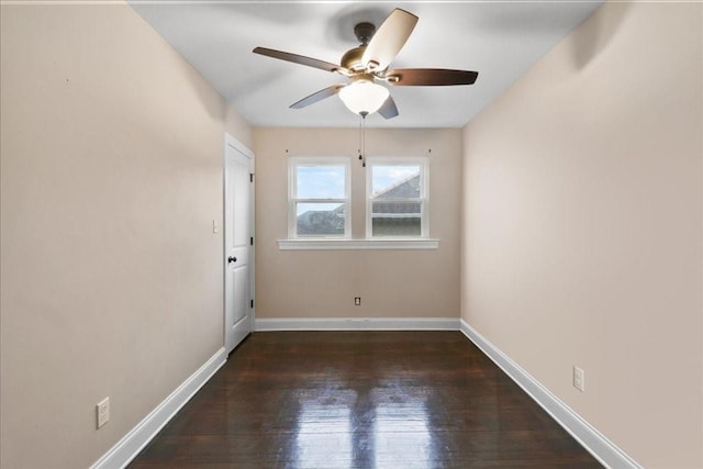 empty room featuring dark wood-type flooring and ceiling fan