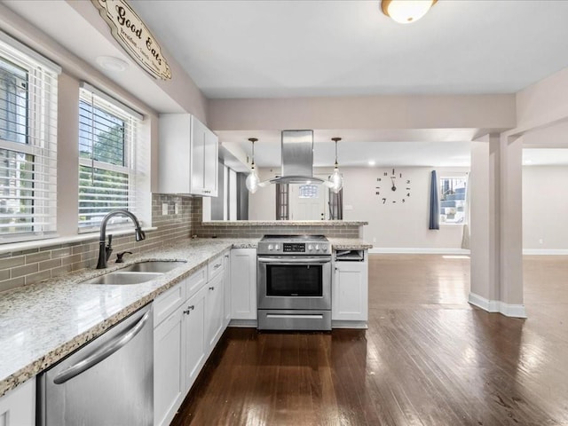 kitchen with sink, island range hood, decorative light fixtures, stainless steel appliances, and white cabinets