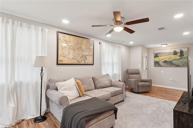 living room featuring ceiling fan and light wood-type flooring