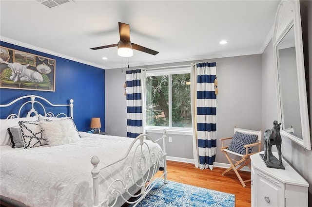 bedroom featuring crown molding, ceiling fan, and hardwood / wood-style floors