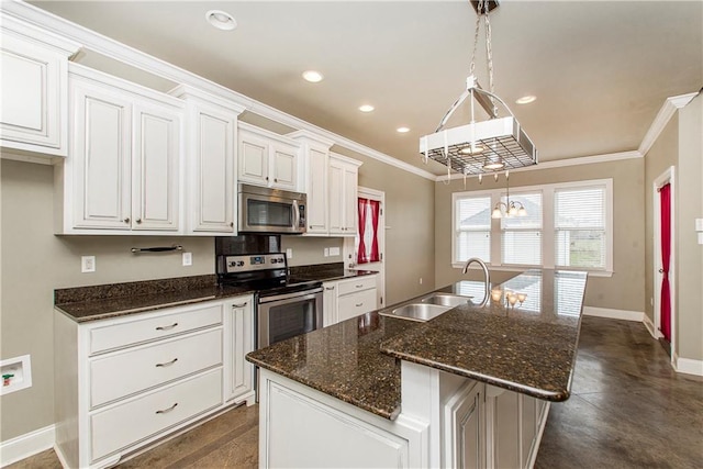 kitchen featuring sink, stainless steel appliances, white cabinets, and a center island with sink