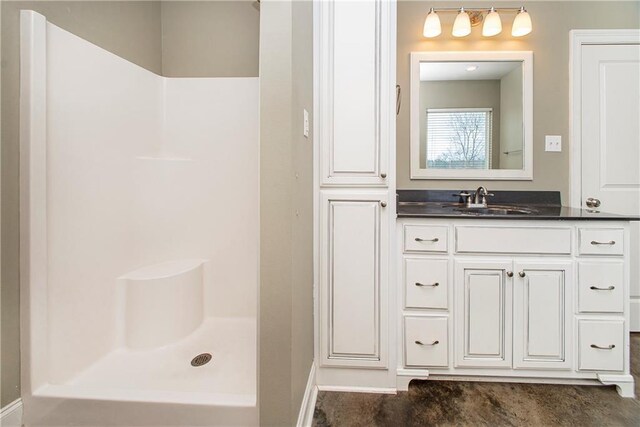 bathroom with vanity and a shower