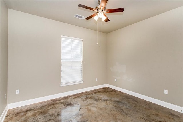 spare room featuring ceiling fan and concrete floors