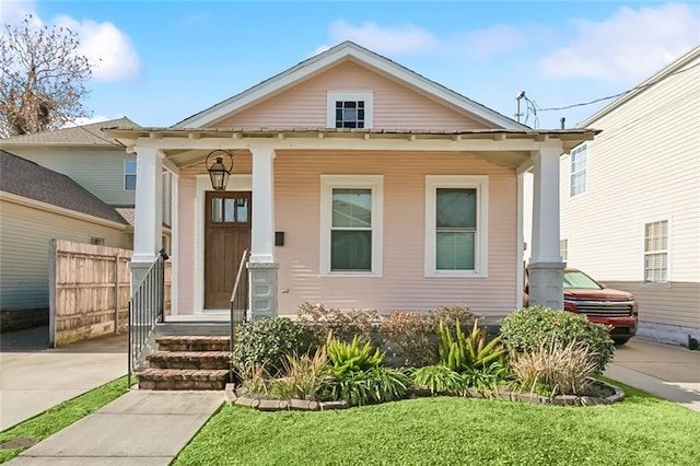 bungalow featuring a porch and a front yard