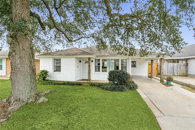 ranch-style home featuring a front yard and a carport