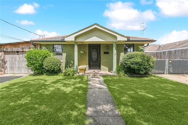 bungalow-style home with a front lawn