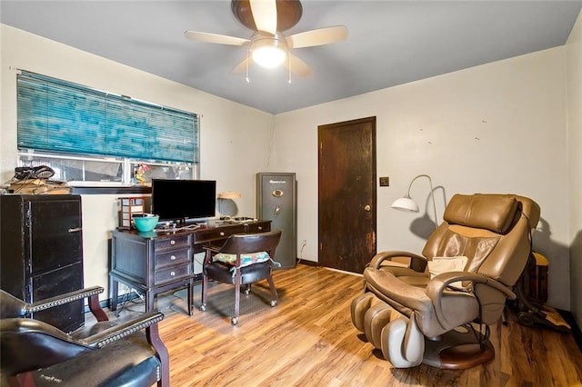 office with light hardwood / wood-style flooring and ceiling fan