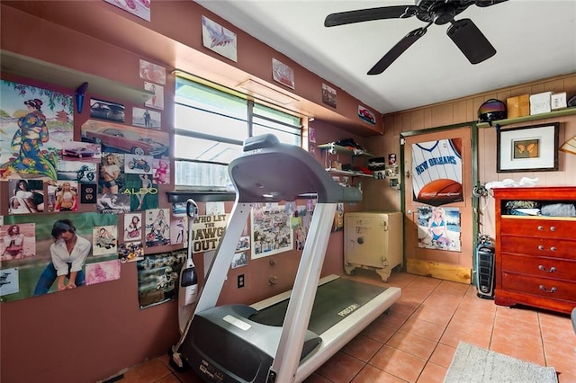 exercise room with light tile patterned flooring and ceiling fan