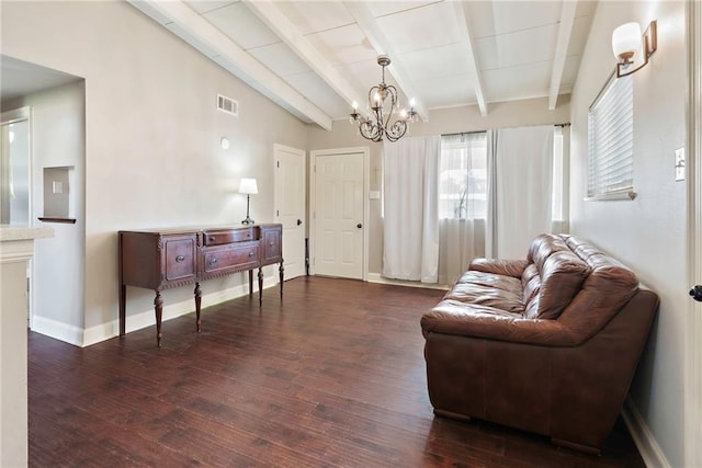 living room featuring dark hardwood / wood-style floors, a chandelier, and lofted ceiling with beams