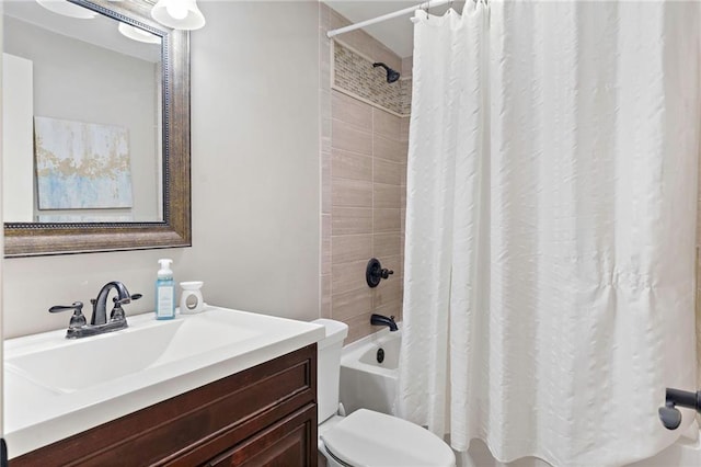 full bathroom with vanity, shower / tub combo, and toilet