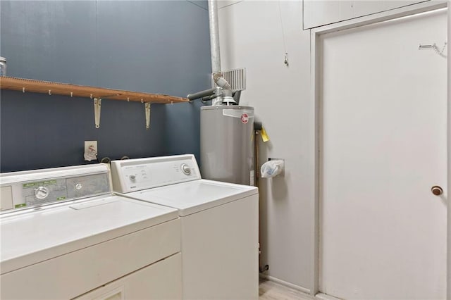 laundry area featuring water heater and independent washer and dryer