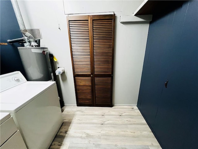 laundry area with water heater, separate washer and dryer, and light hardwood / wood-style flooring