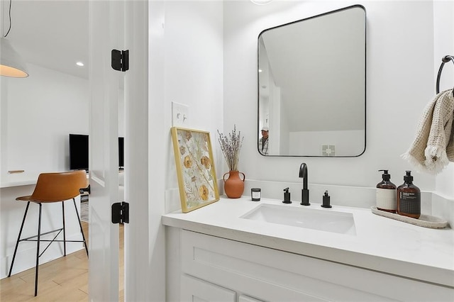 bathroom featuring hardwood / wood-style flooring and vanity