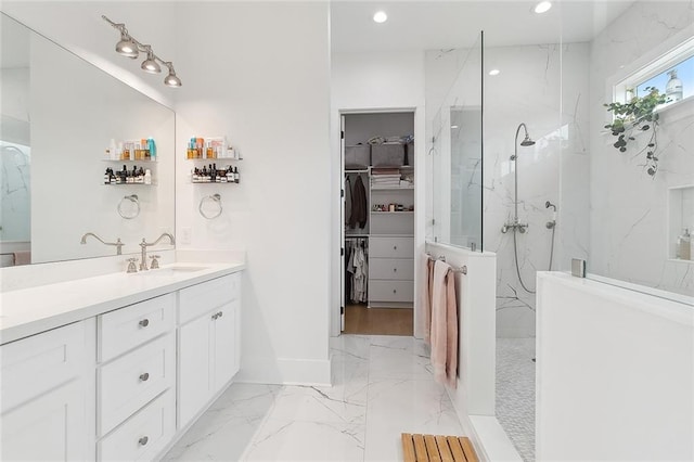 bathroom featuring vanity and tiled shower