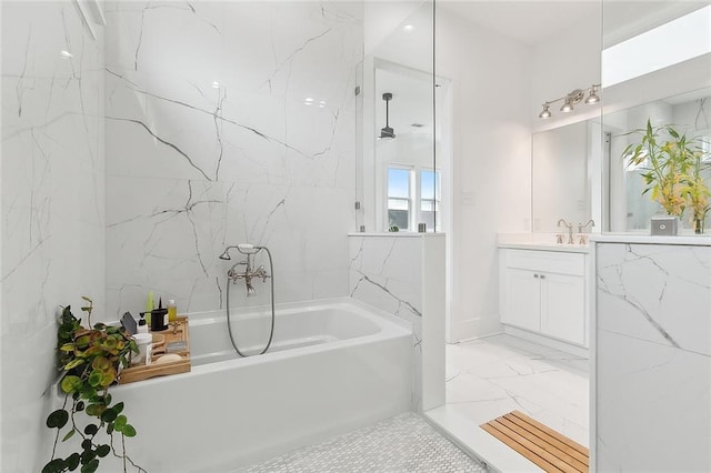 bathroom featuring vanity and a washtub