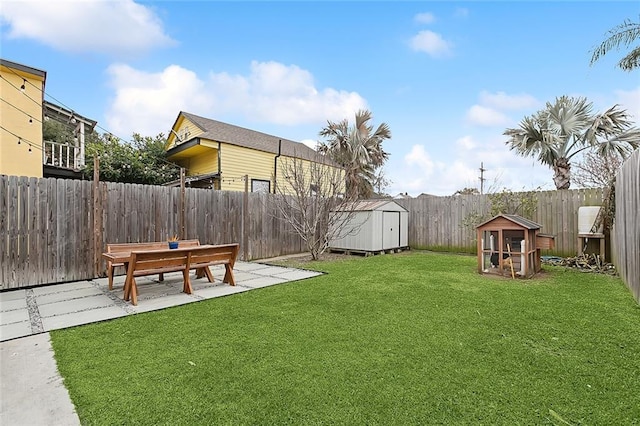 view of yard with a storage shed and a patio area