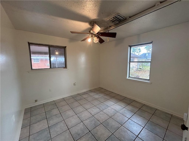204 Magnolia Ave, La Place, LA 70068 - tiled empty room featuring ceiling fan and a textured ceiling