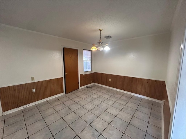 204 Magnolia Ave, La Place, LA 70068 - empty room with ornamental molding, a chandelier, a textured ceiling, and wooden walls
