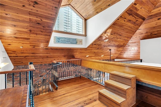 additional living space with wood walls, high vaulted ceiling, light wood-type flooring, and wooden ceiling