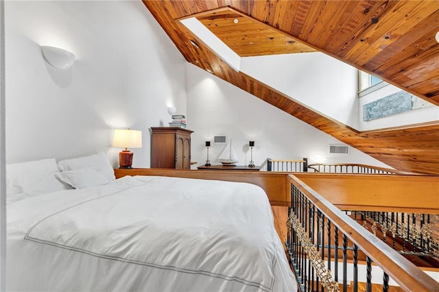 bedroom with wooden ceiling, high vaulted ceiling, and a skylight