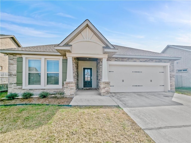 view of front of house featuring a garage and a front yard