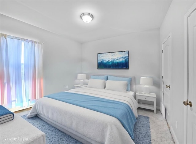 carpeted bedroom featuring multiple windows