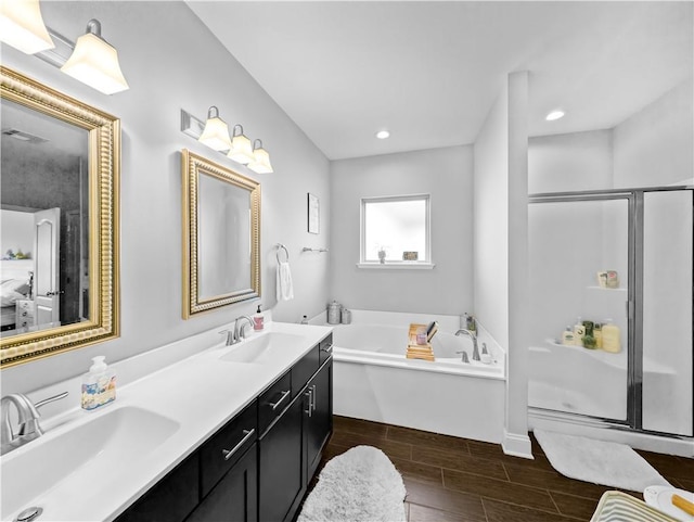 bathroom featuring plus walk in shower and vanity