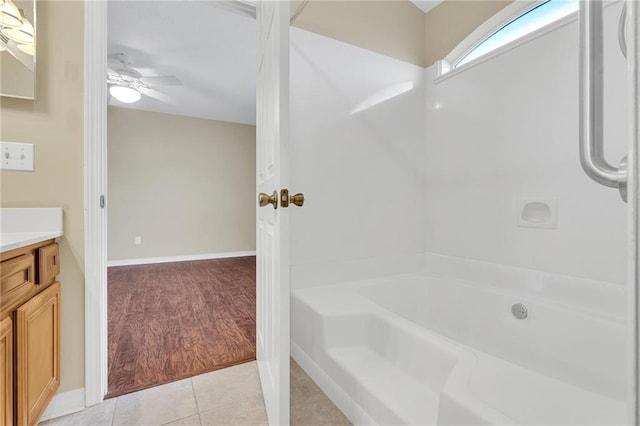 bathroom with vanity, a bathing tub, tile patterned floors, and ceiling fan