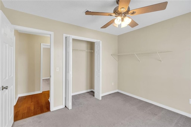 unfurnished bedroom with light colored carpet, a closet, and ceiling fan