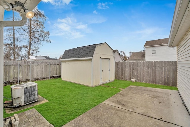 view of yard featuring central AC unit, a patio area, and a storage unit