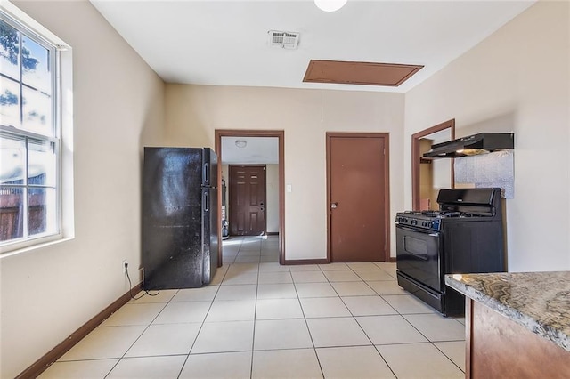 kitchen with light tile patterned flooring and black appliances