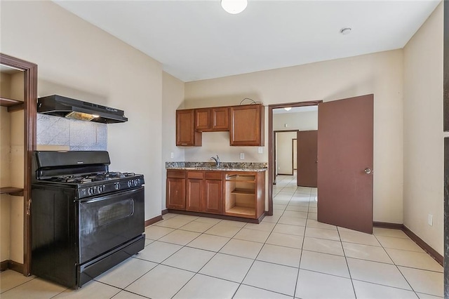 kitchen featuring sink, range hood, gas stove, and light tile patterned flooring