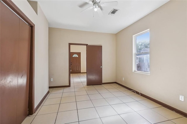 spare room featuring light tile patterned flooring and ceiling fan