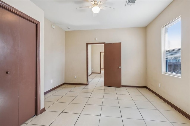 unfurnished bedroom with a closet, ceiling fan, and light tile patterned flooring